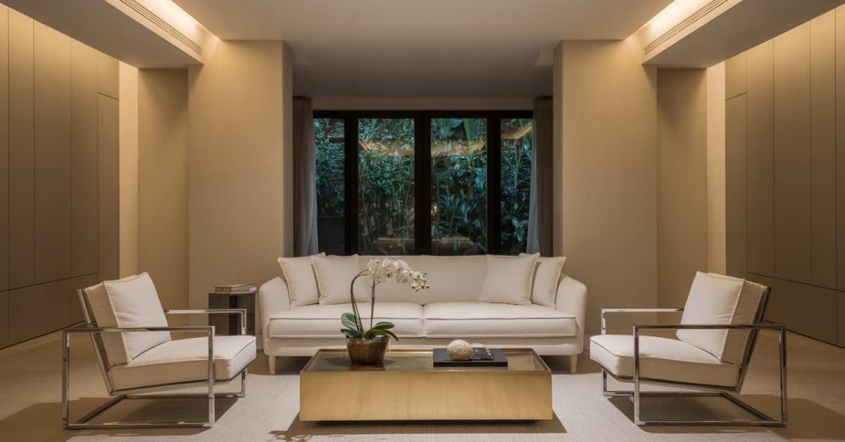 Decoração de sala pequena de luxo com sofás neutros e detalhes metálicos.